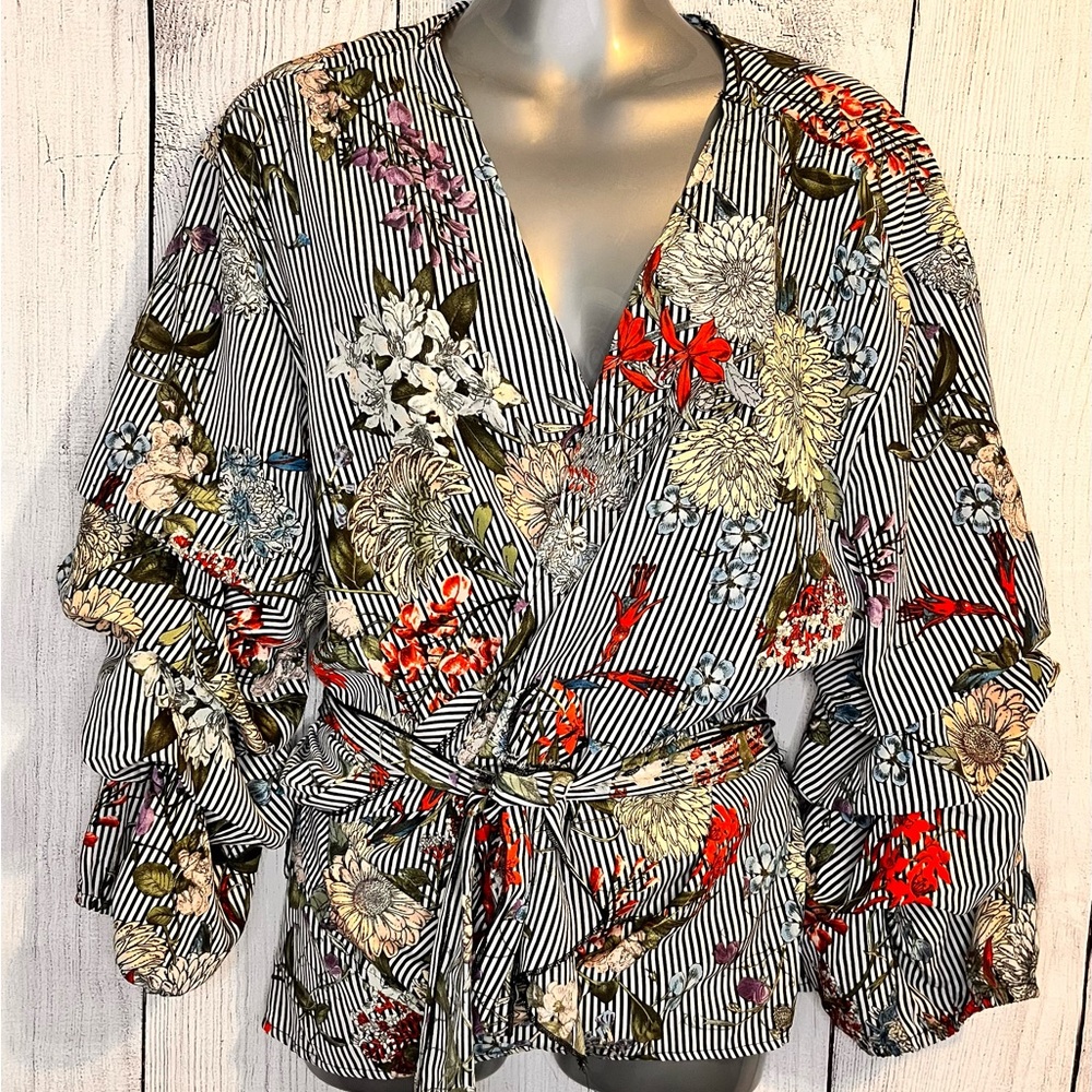 This really pretty wrap shirt is made by unique spectrum sized 1X